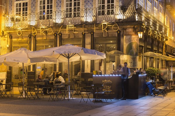 Famous Brasileira cafe illuminated at sunset