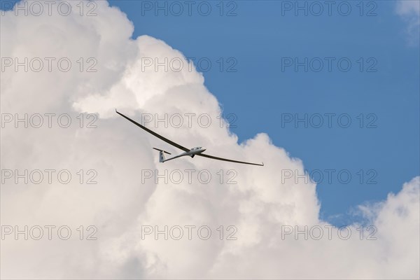 Glider flying in a cloudy sky