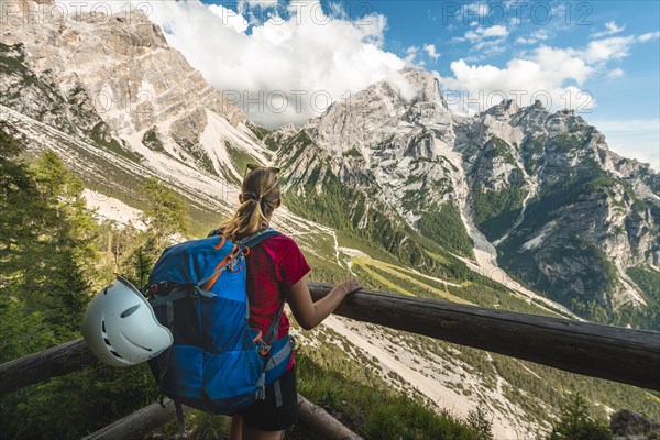 Hiker overlooks mountain landscape