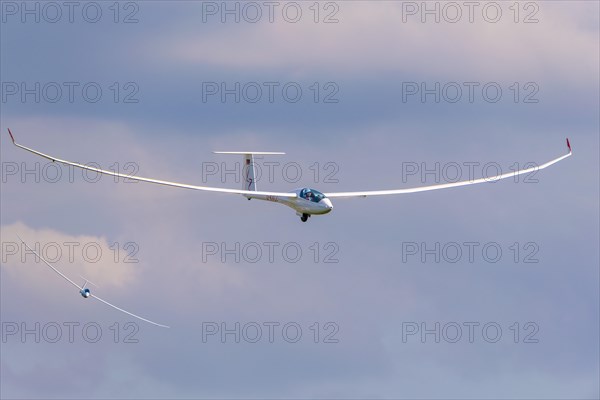 Glider flying in a cloudy sky