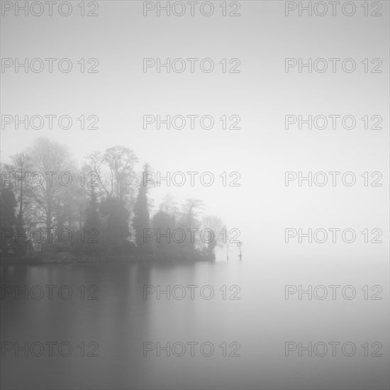 Tip of the castle island on the Dahme in Berlin Koepenick in the early morning in the thick fog