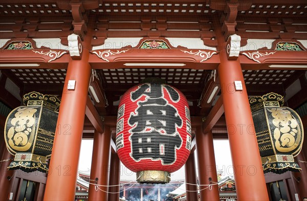 Large red Chochin lantern and two copper lanterns