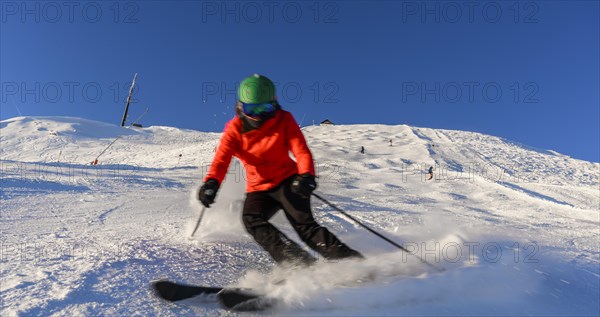 Skier descending a steep slope