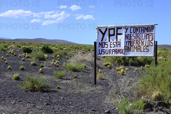 Protest sign against the oil company YPF on the side of the Ruta 40