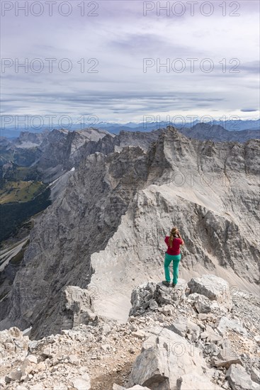 Woman standing on rocks and photographed