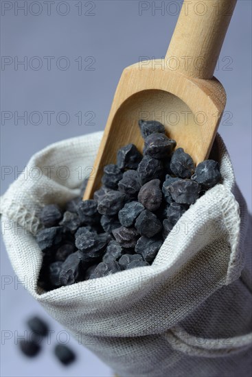 Black chickpeas in sack and wooden shovel