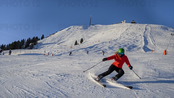 Skier descending a steep slope