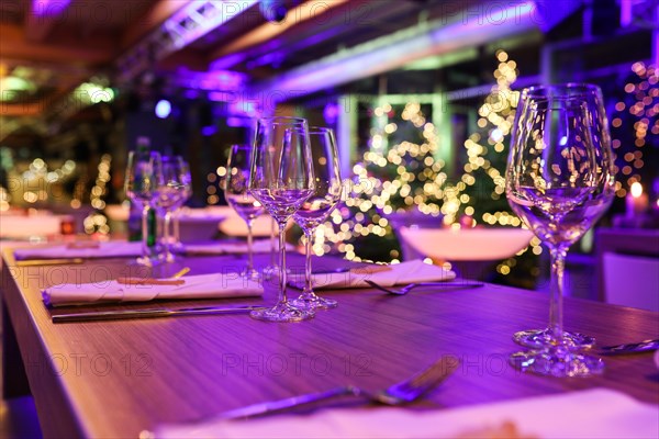 Table set for a Christmas party with wine glasses and Christmas decorations