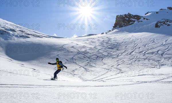 Snowboarder with splitboard rides in the snow