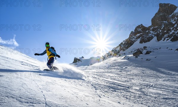 Snowboarder with splitboard rides in the snow