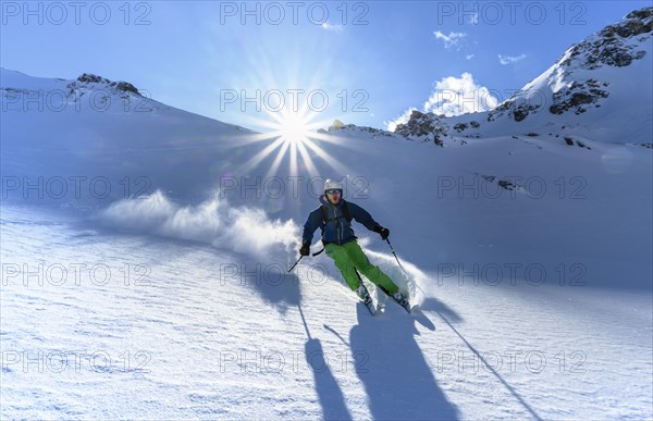 Skier with touring skis skiing in the snow