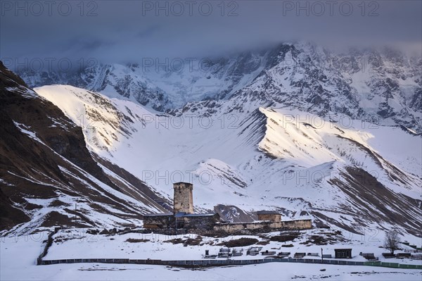 Watchtower in front of a mountain scenery at sunrise