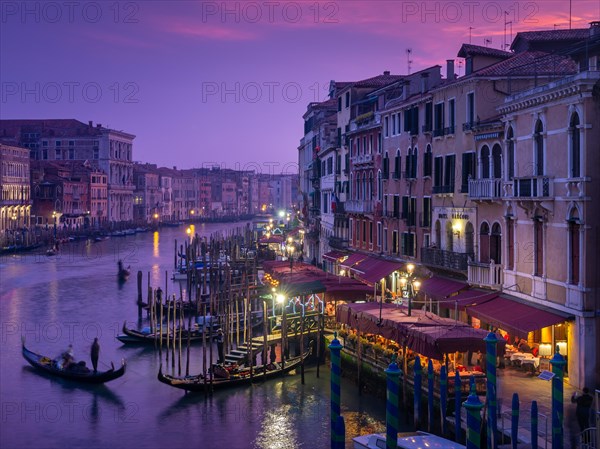 View from the Rialto Bridge on the Canal Grande with gondolier at sunset