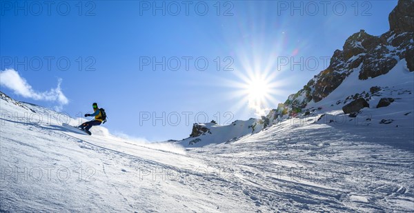 Snowboarder with splitboard rides in the snow