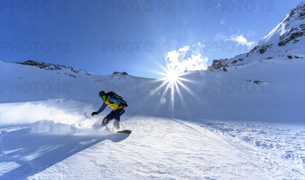 Snowboarder with splitboard rides in the snow