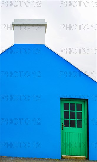 Blue house facade with green front door