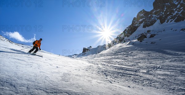 Skier with touring skis skiing in the snow