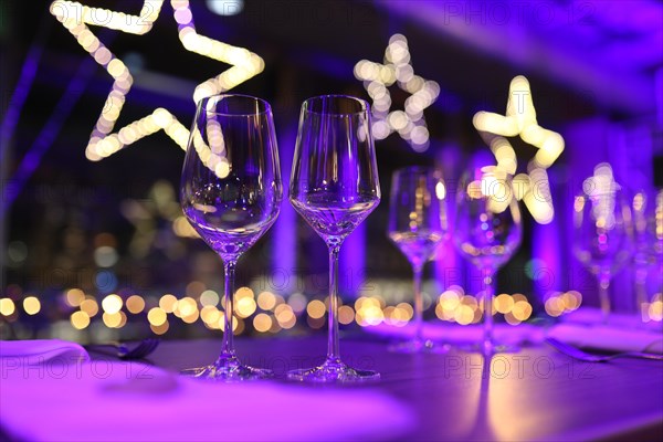 Table set for a Christmas party with wine glasses and Christmas decorations