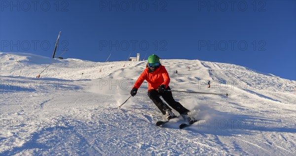 Skier descending a steep slope