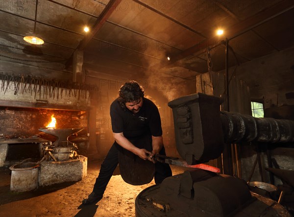 Blacksmith at the forge hammer