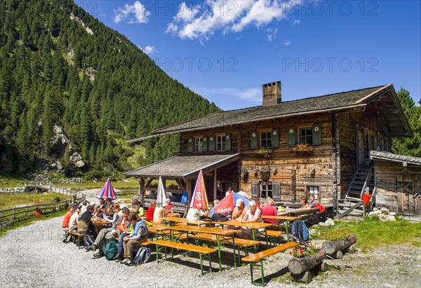 Managed alpine hut with hiker