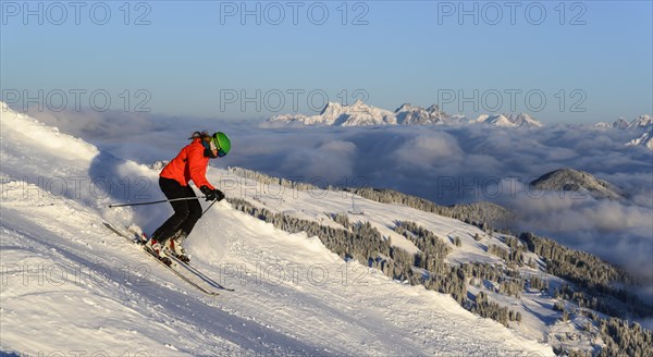 Female skier descending steep slope