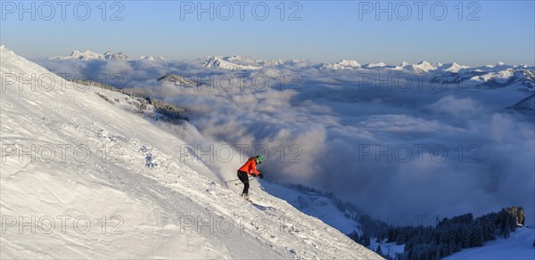 Female skier descending steep slope