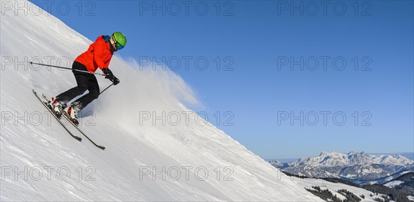 Skier going down steep slope