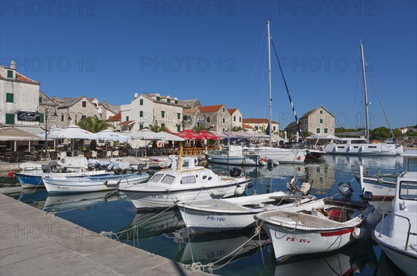 Promenade with fishing boats in the port