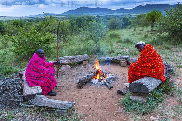 Maasai men around a campfire