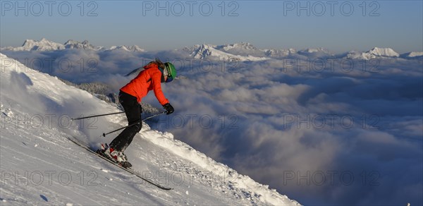 Female skier descending steep slope