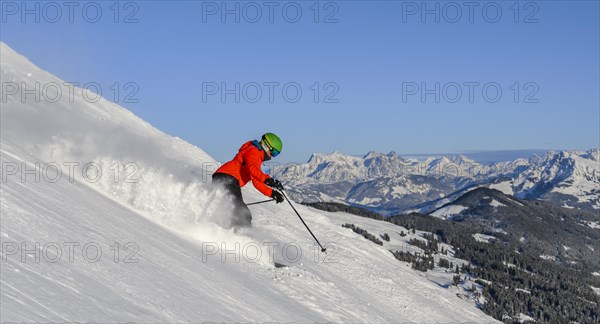 Skier going down steep slope