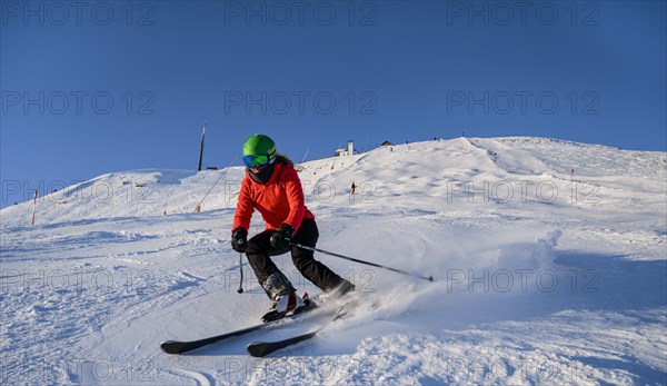 Skier descending a steep slope