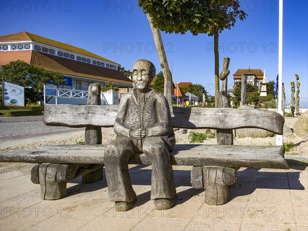 Park bench with wood sculpture