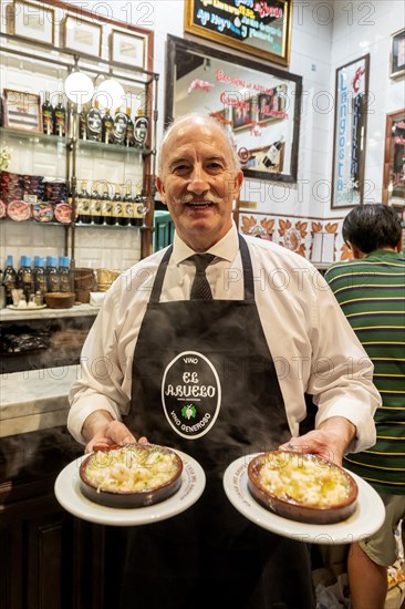 Waiter with Gambas al Ajillo