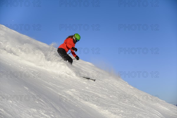 Skier descending steep slope