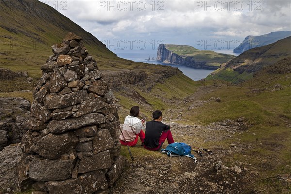 Two hikers taking a break with a view of the Atlantic Ocean