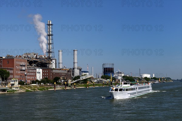 Rhine with excursion boat and industrial plants of BASF