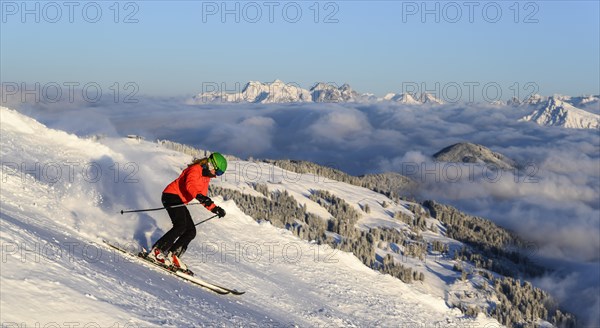 Female skier descending steep slope