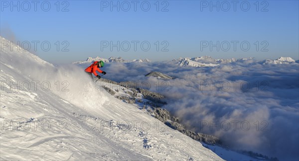 Female skier descending steep slope