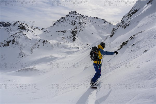 Ski tourers with splitboard on the downhill run