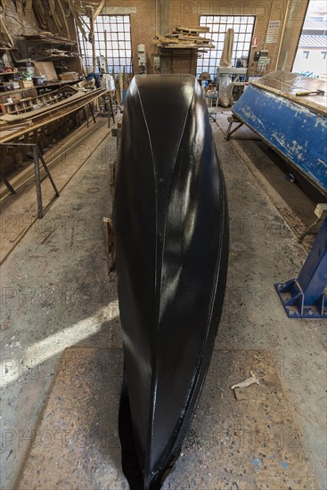 Freshly lined hull of a gondola in a boatyard on the island of Guidecca