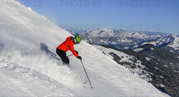 Skier going down steep slope