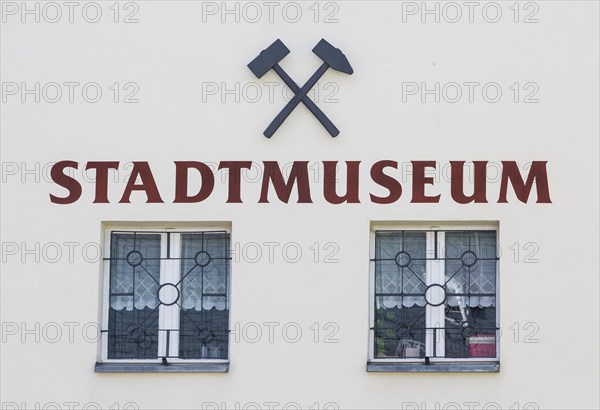 Inscription city museum with symbol mallet and iron