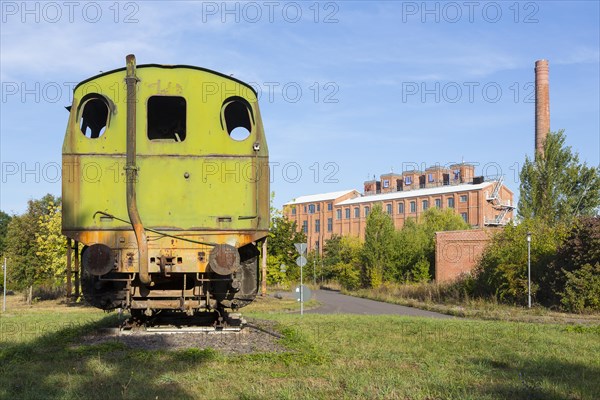 Old locomotive and factory buildings