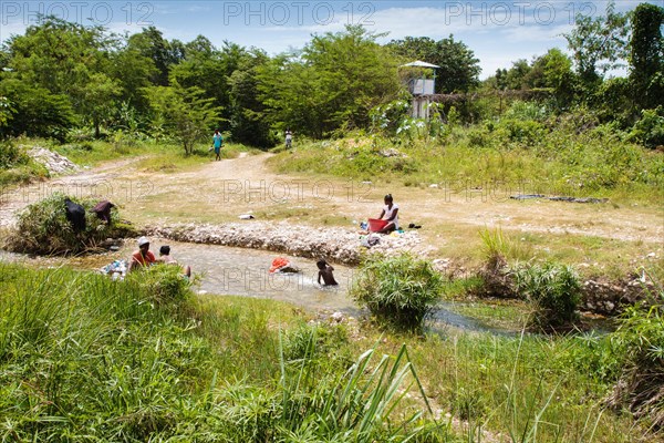 Woman washing clothes on the river