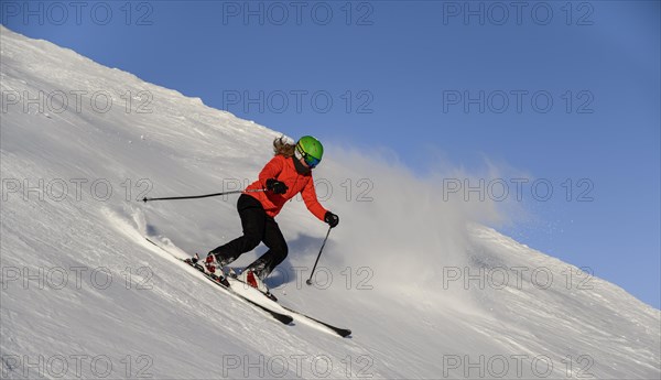 Skier descending steep slope