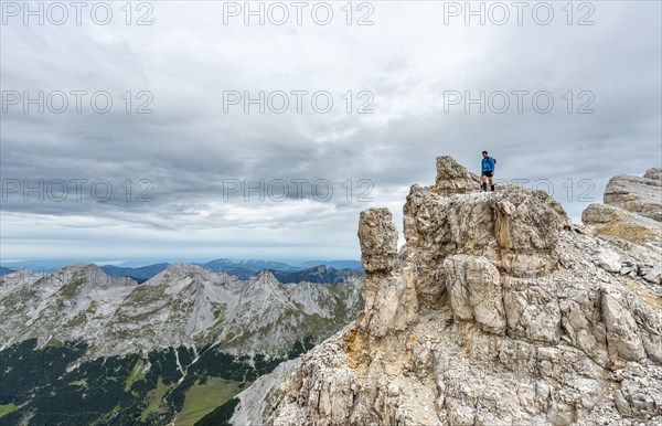 Mountaineer stands on a rock