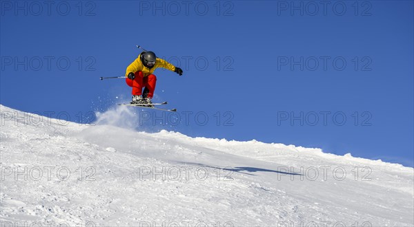 Skiers jumping on the ski slope