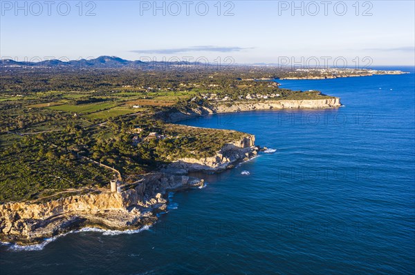 Steep coast with watchtower Torre d'en Beu near Cala Figuera